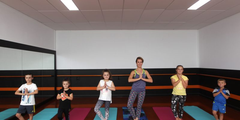 Students practicing yoga with teacher